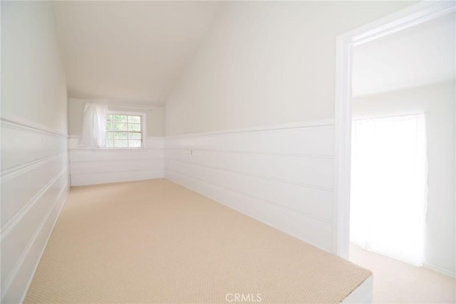 251 W 112th St, Los Angeles, CA 90061 - additional living space featuring light colored carpet, lofted ceiling, and wainscoting