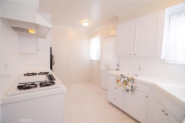 251 W 112th St, Los Angeles, CA 90061 - kitchen featuring extractor fan, white gas stovetop, white cabinetry, and light countertops