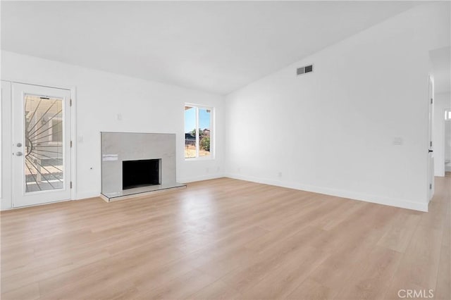 7720 Windsor Ave, Hesperia, CA 92345 - unfurnished living room featuring light wood-style floors and a fireplace with raised hearth