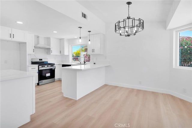 7720 Windsor Ave, Hesperia, CA 92345 - kitchen with stainless steel range with gas stovetop, wall chimney range hood, a chandelier, light wood-style flooring, and recessed lighting