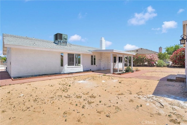 7720 Windsor Ave, Hesperia, CA 92345 - rear view of house with stucco siding, a chimney, and a patio