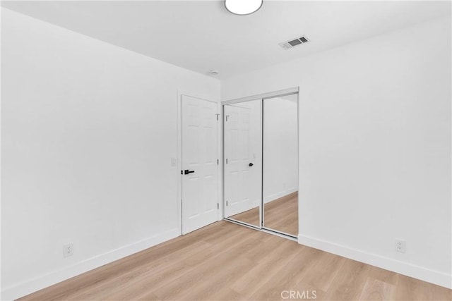 7720 Windsor Ave, Hesperia, CA 92345 - unfurnished bedroom featuring light wood-style flooring and a closet