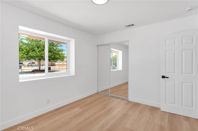 7720 Windsor Ave, Hesperia, CA 92345 - unfurnished bedroom with light wood-style flooring and a closet