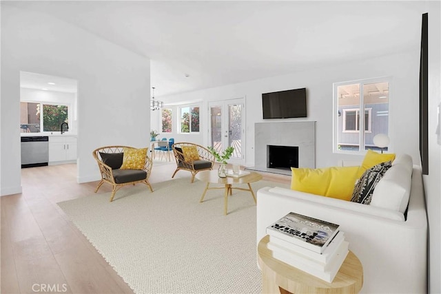 7720 Windsor Ave, Hesperia, CA 92345 - living room with a high end fireplace, wood finished floors, and french doors