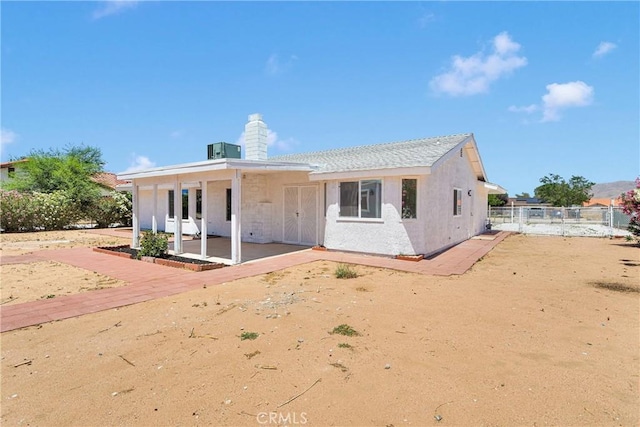 7720 Windsor Ave, Hesperia, CA 92345 - back of property featuring a patio area and a chimney