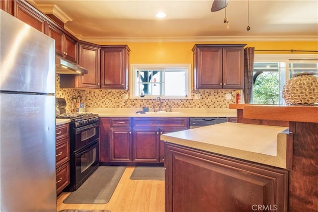 52685 Saddleback Rd, Anza, CA 92539 - kitchen featuring freestanding refrigerator, double oven range, under cabinet range hood, crown molding, and light countertops