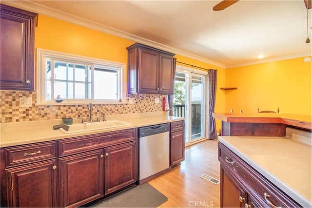 52685 Saddleback Rd, Anza, CA 92539 - kitchen with stainless steel dishwasher, crown molding, light wood-type flooring, light countertops, and decorative backsplash