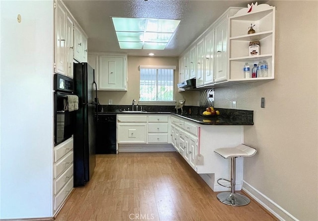636 NW Avenida Sevilla # O, Laguna Woods, CA 92637 - kitchen with black appliances, light wood-type flooring, dark countertops, white cabinetry, and open shelves
