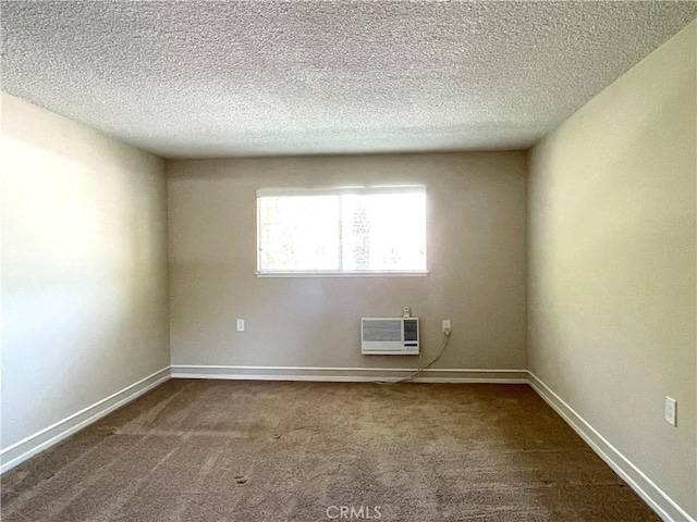 636 NW Avenida Sevilla # O, Laguna Woods, CA 92637 - spare room with dark carpet, a wall mounted AC, and a textured ceiling