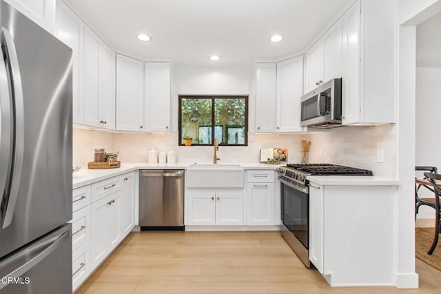 3015 Henrietta Ave, La Crescenta, CA 91214 - kitchen featuring appliances with stainless steel finishes, recessed lighting, light countertops, white cabinets, and backsplash