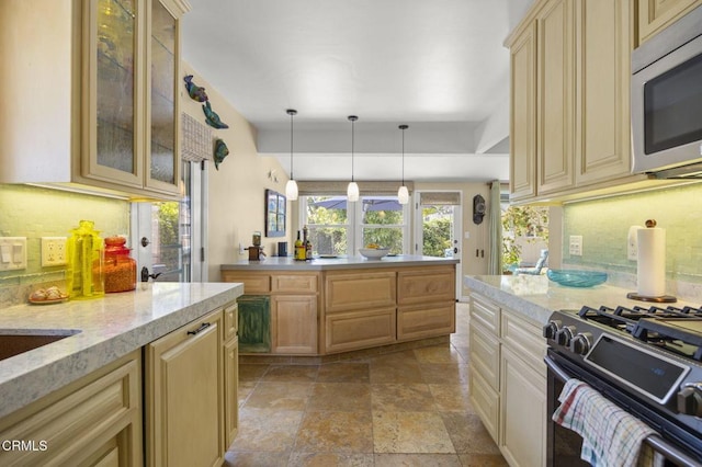 401 S Brent St, Ventura, CA 93003 - kitchen with stainless steel microwave, black range with gas cooktop, stone tile flooring, and decorative backsplash