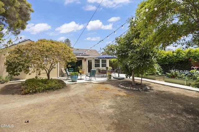 401 S Brent St, Ventura, CA 93003 - back of property featuring a patio area, roof mounted solar panels, and stucco siding