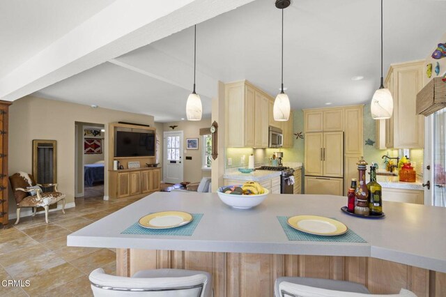 401 S Brent St, Ventura, CA 93003 - kitchen featuring appliances with stainless steel finishes, light countertops, a breakfast bar, and a heating unit