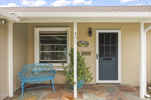 401 S Brent St, Ventura, CA 93003 - view of exterior entry with roof with shingles, stucco siding, and covered porch