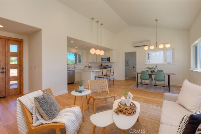 866 Central Park Dr, Paradise, CA 95969 - living room featuring a wall unit AC, light wood-style floors, healthy amount of natural light, and high vaulted ceiling