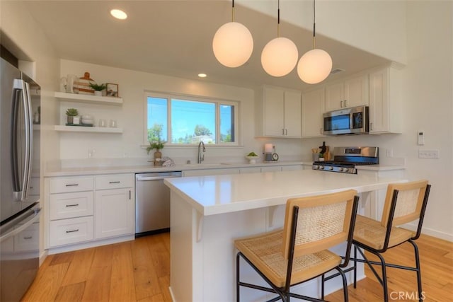 866 Central Park Dr, Paradise, CA 95969 - kitchen featuring appliances with stainless steel finishes, a breakfast bar, light countertops, white cabinets, and recessed lighting