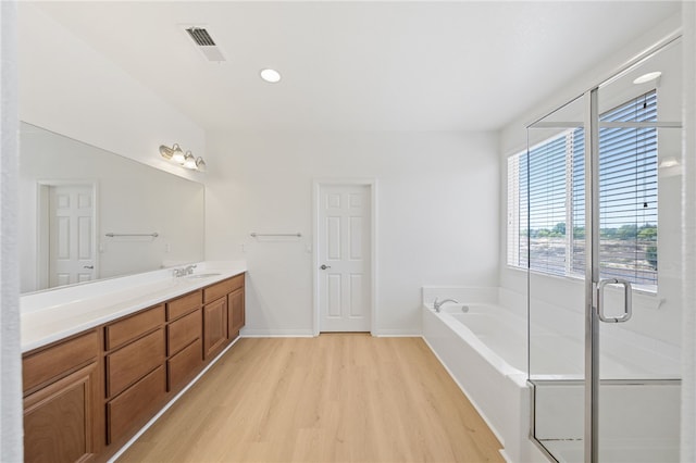 23812 Cook Ct, Wildomar, CA 92595 - full bathroom featuring wood finished floors, a garden tub, vanity, and recessed lighting