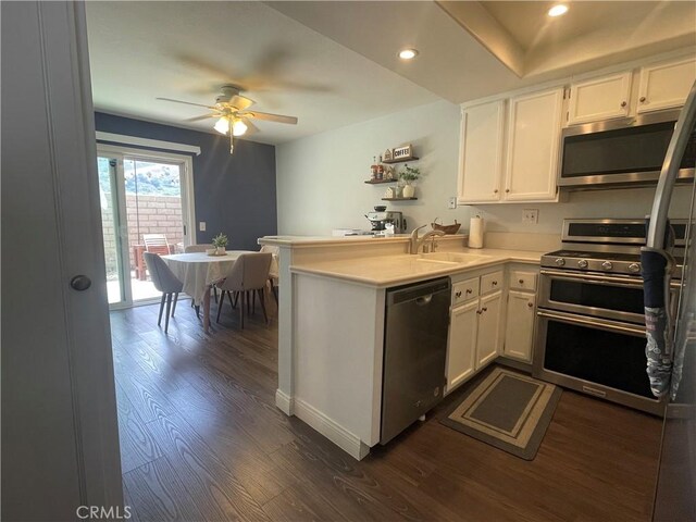 23330 Dover Ln Unit 94, Yorba Linda, CA 92887 - kitchen featuring stainless steel appliances, a peninsula, dark wood-style floors, ceiling fan, and white cabinetry