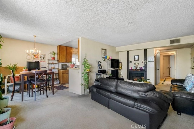 13903 Sherman Way Unit 8, Van Nuys, CA 91405 - living room featuring light carpet, a chandelier, and a textured ceiling