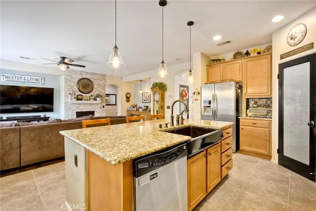 44837 Checkerbloom Dr, Temecula, CA 92592 - kitchen with stainless steel appliances, ceiling fan, light tile patterned floors, a kitchen island with sink, and recessed lighting