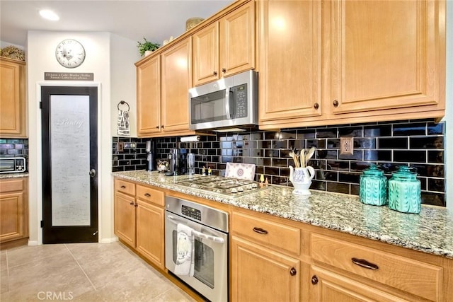 44837 Checkerbloom Dr, Temecula, CA 92592 - kitchen featuring stainless steel appliances, light stone countertops, light tile patterned flooring, and decorative backsplash