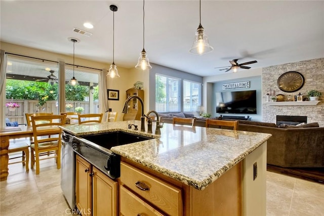 44837 Checkerbloom Dr, Temecula, CA 92592 - kitchen featuring a ceiling fan, an island with sink, a large fireplace, and light stone counters
