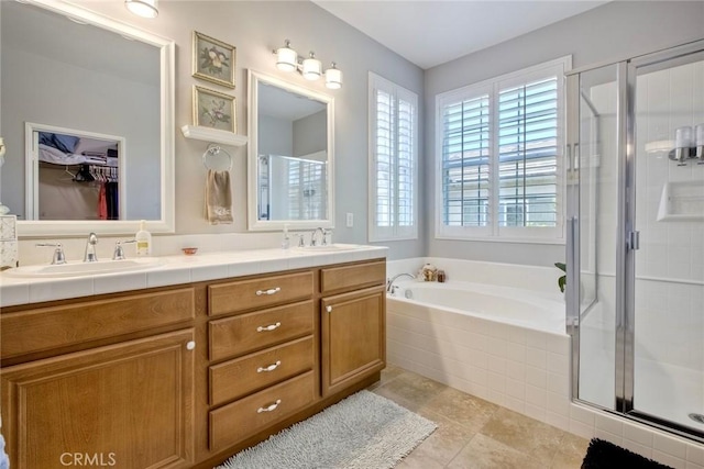 44837 Checkerbloom Dr, Temecula, CA 92592 - bathroom with double vanity, a bath, a shower stall, tile patterned flooring, and a walk in closet