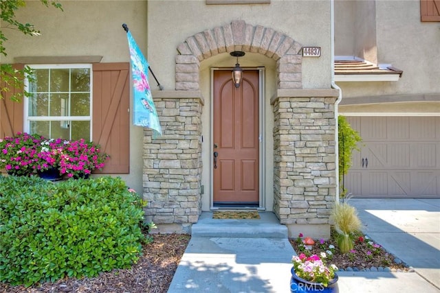 44837 Checkerbloom Dr, Temecula, CA 92592 - entrance to property with stone siding, stucco siding, and a garage