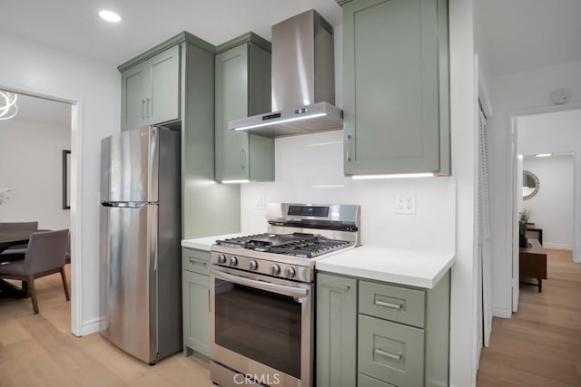 1440 Riviera Dr, Pasadena, CA 91107 - kitchen featuring wall chimney exhaust hood, appliances with stainless steel finishes, green cabinetry, light wood-style floors, and recessed lighting