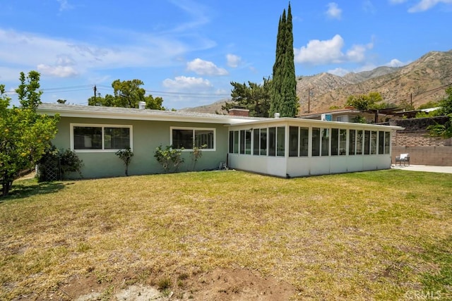 1440 Riviera Dr, Pasadena, CA 91107 - back of property featuring a sunroom, a lawn, a mountain view, and stucco siding