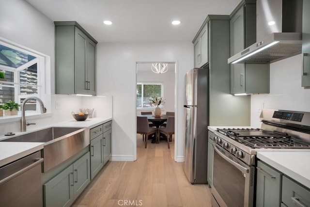 1440 Riviera Dr, Pasadena, CA 91107 - kitchen with stainless steel appliances, wall chimney range hood, light wood-type flooring, light countertops, and recessed lighting