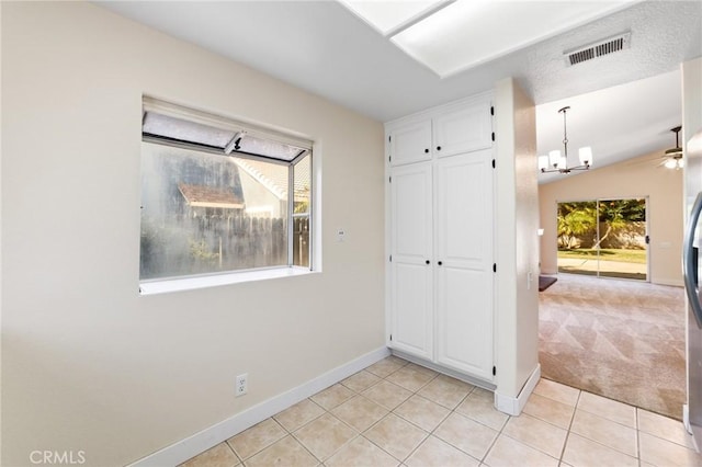 4108 Sunnysage Dr, Jurupa Valley, CA 92509 - unfurnished bedroom with light tile patterned flooring, a chandelier, a closet, light colored carpet, and refrigerator