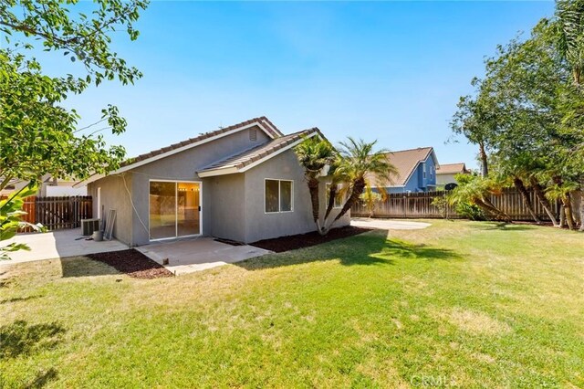 4108 Sunnysage Dr, Jurupa Valley, CA 92509 - rear view of house with stucco siding, a patio area, a fenced backyard, and a tile roof