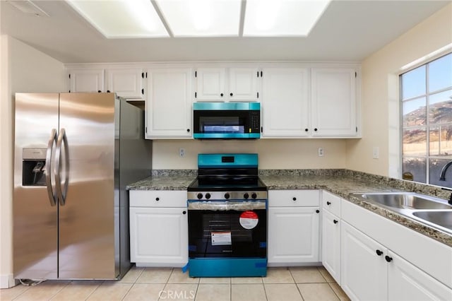 4108 Sunnysage Dr, Jurupa Valley, CA 92509 - kitchen with stainless steel appliances, white cabinets, and light tile patterned floors