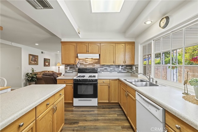26817 Oak Branch Cir, Newhall, CA 91321 - kitchen with white appliances, under cabinet range hood, light countertops, dark wood-style floors, and tasteful backsplash