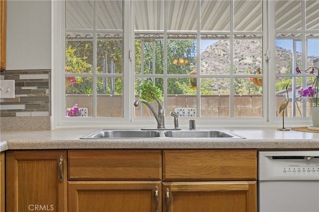 26817 Oak Branch Cir, Newhall, CA 91321 - kitchen featuring dishwasher, light countertops, plenty of natural light, and brown cabinets