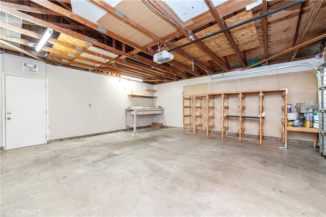 9411 Friendly Woods Ln, Whittier, CA 90605 - garage with a workshop area and a garage door opener