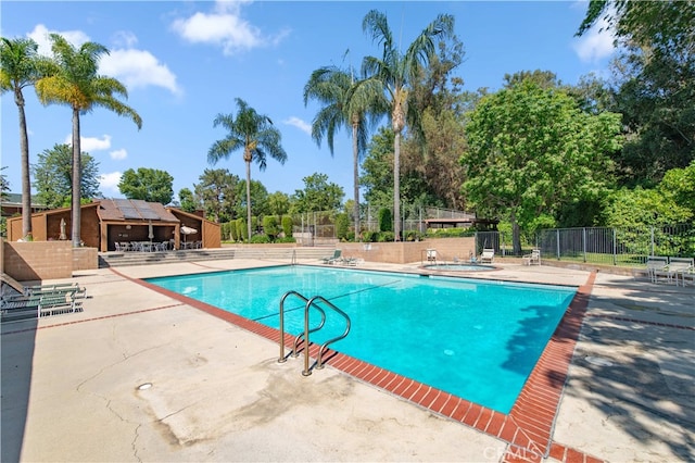 9411 Friendly Woods Ln, Whittier, CA 90605 - community pool with a patio area and view of scattered trees