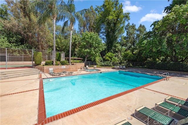 9411 Friendly Woods Ln, Whittier, CA 90605 - community pool with a hot tub, view of scattered trees, and a patio