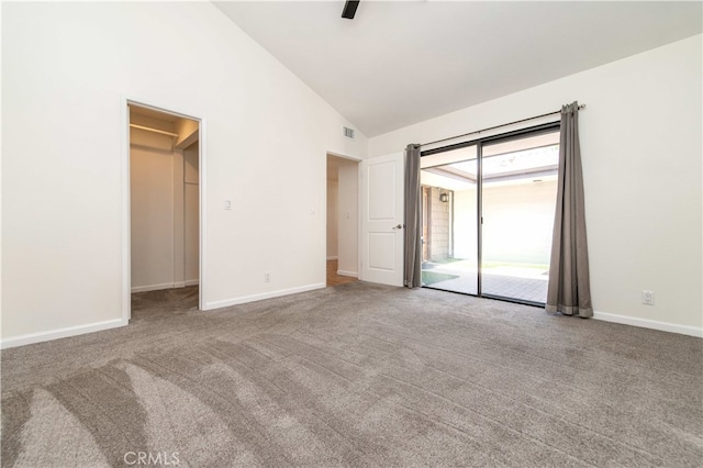 9411 Friendly Woods Ln, Whittier, CA 90605 - unfurnished bedroom featuring access to outside, carpet, a walk in closet, a ceiling fan, and high vaulted ceiling