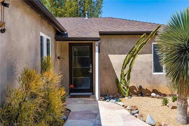 2023 Republic Ave, Costa Mesa, CA 92627 - view of exterior entry with a shingled roof and stucco siding