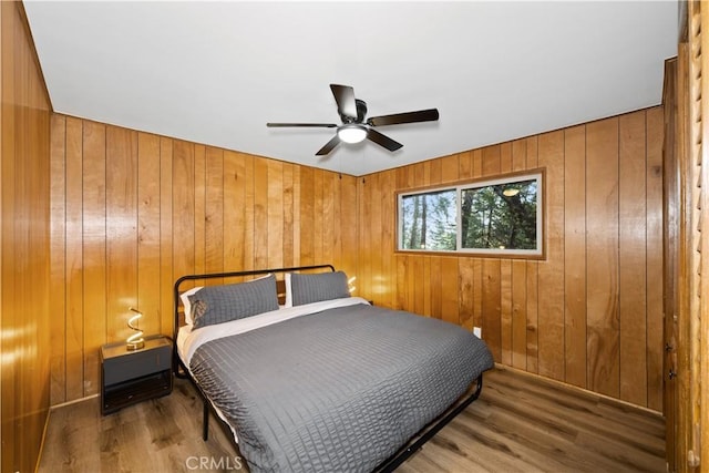 990 Nesthorn Dr, Crestline, CA 92325 - bedroom featuring wooden walls, wood finished floors, and a ceiling fan