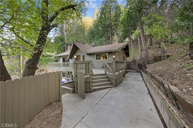 990 Nesthorn Dr, Crestline, CA 92325 - view of front of property with a deck and a chimney
