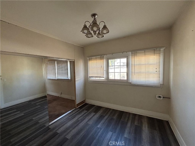 1646 Cimarron St, Los Angeles, CA 90019 - spare room featuring a chandelier and dark wood-style flooring