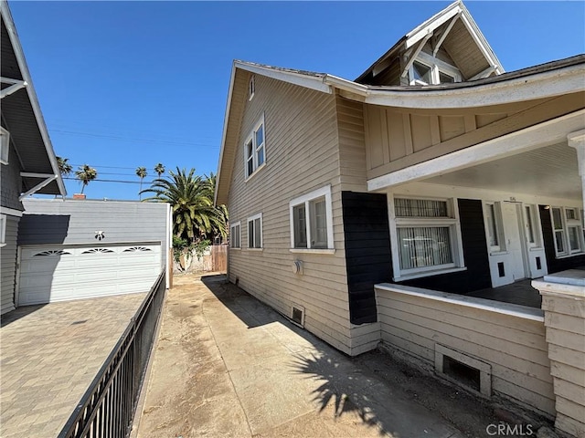 1646 Cimarron St, Los Angeles, CA 90019 - view of side of property with board and batten siding and a detached garage