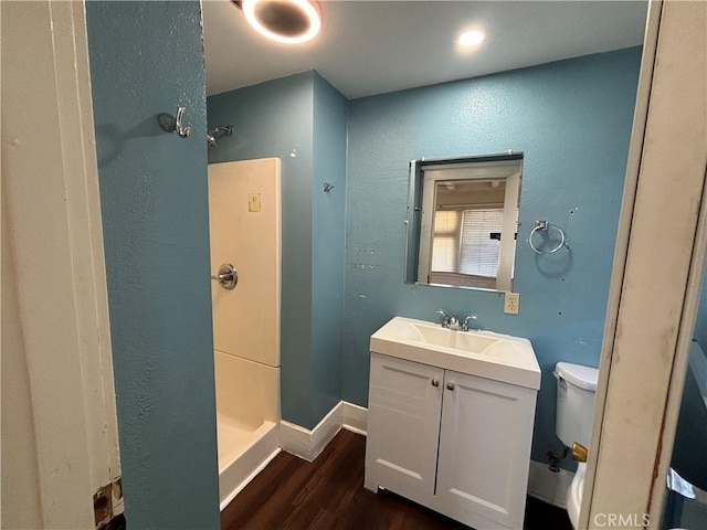 1646 Cimarron St, Los Angeles, CA 90019 - bathroom featuring a stall shower, wood finished floors, vanity, and a textured wall