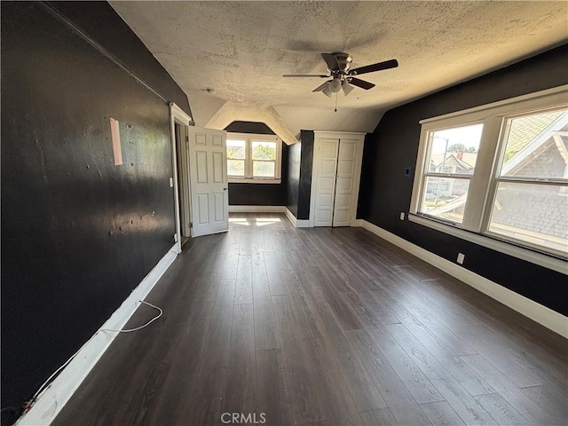1646 Cimarron St, Los Angeles, CA 90019 - unfurnished living room with vaulted ceiling, ceiling fan, dark wood finished floors, and a textured ceiling