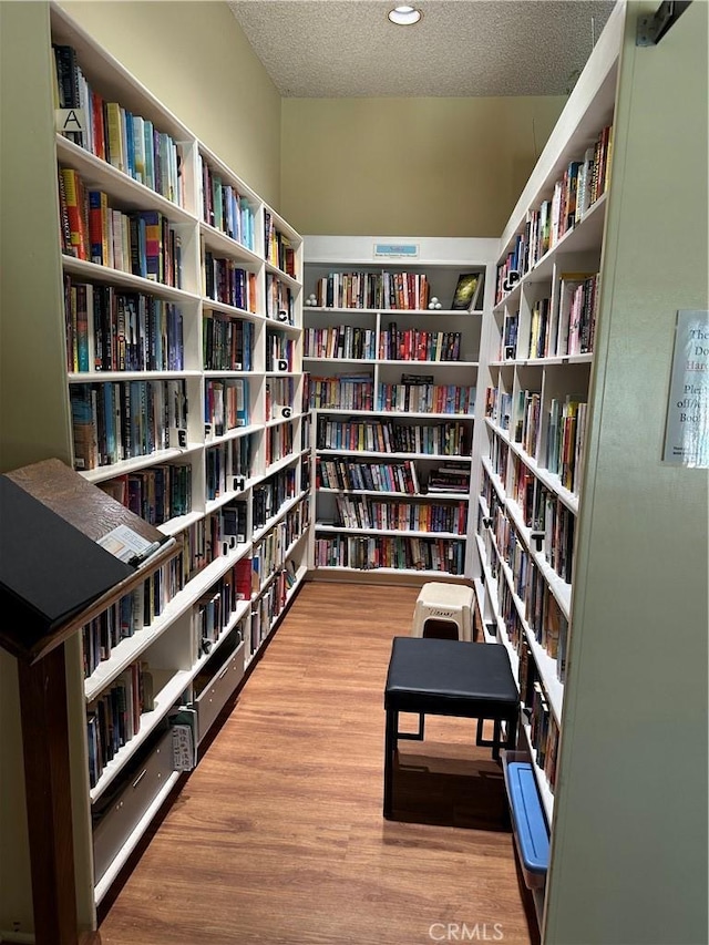 22943 Maple Ave Unit A, Torrance, CA 90505 - sitting room with bookshelves, a textured ceiling, and wood finished floors