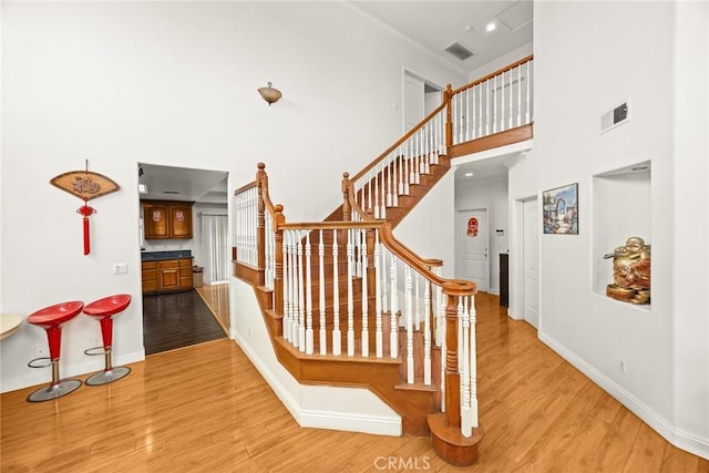 3453 Ivar Ave, Rosemead, CA 91770 - stairs featuring wood finished floors, a towering ceiling, and ornamental molding