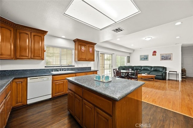 3453 Ivar Ave, Rosemead, CA 91770 - kitchen with dishwasher, dark countertops, dark wood-style flooring, a center island, and brown cabinetry